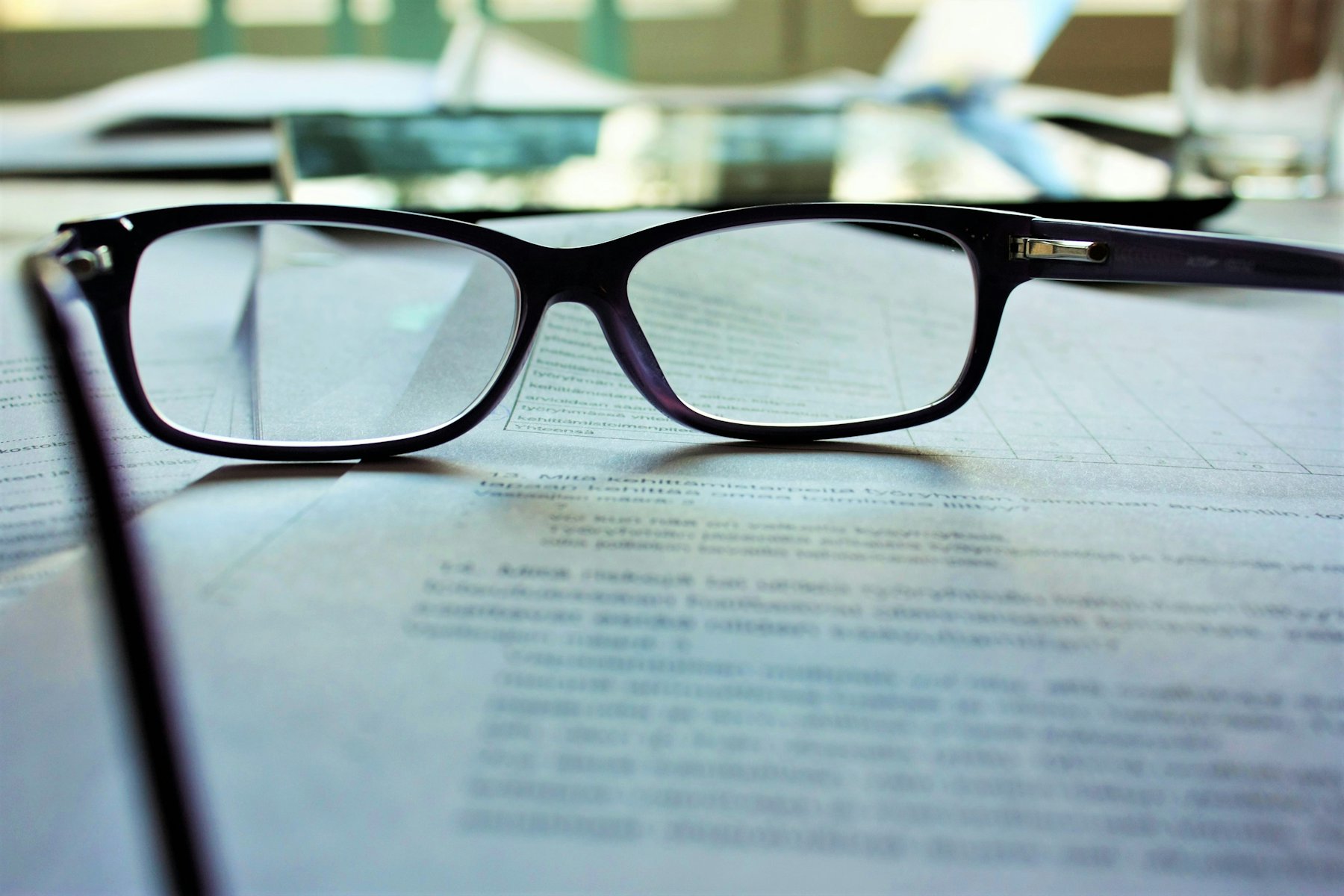 Eyeglasses resting on printed drawings