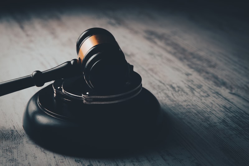 A judge's gavel resting on a wooden table